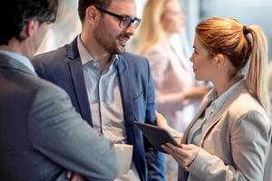 Woman-with-tablet-talking-to-man-about-business
