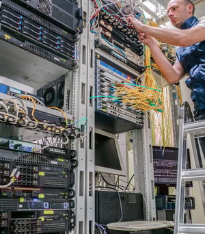 technician-wiring-cables-onto-server-rack