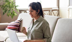 woman-talking-on-virtual-conference-sitting-on-the-couch