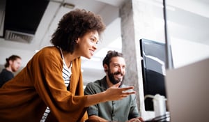 man-and-woman-working-together-on-a-computer