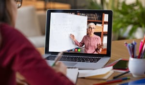 student-watching-teacher-on-laptop