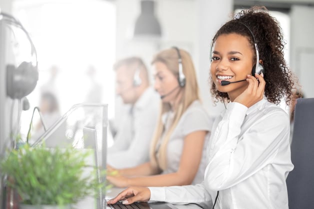 smiling female support agent wearing headset