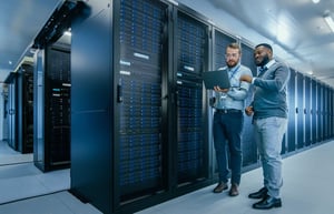 it staff working together to configure syste,
