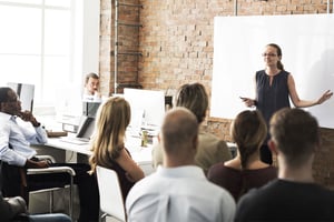 group-of-peeople-in-front-of-a-business-presentation