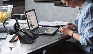 woman-working-from-home-with-polycom-vvx-phone-on-desk